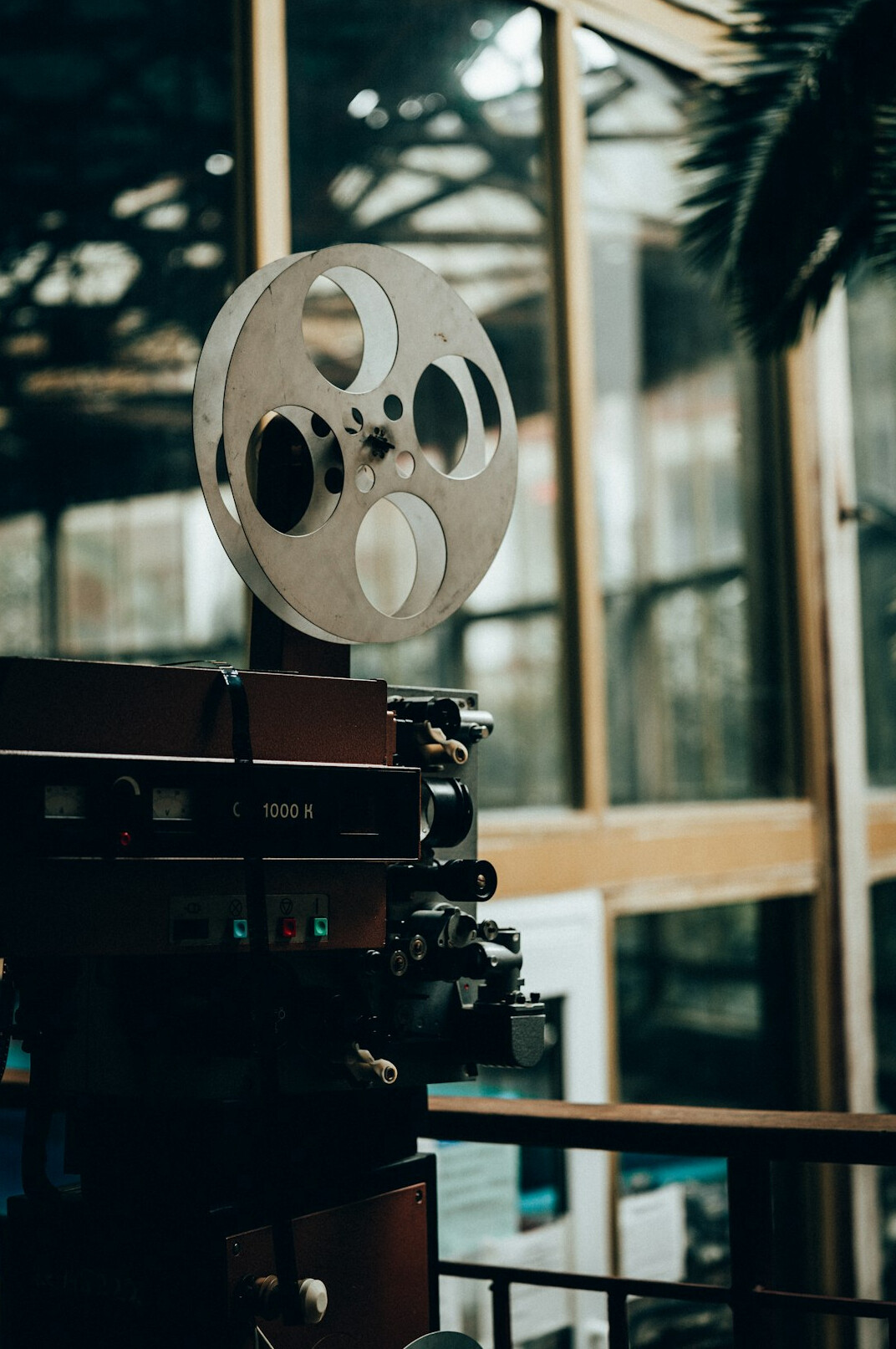 Vintage film reels and a film splicer on an editing table