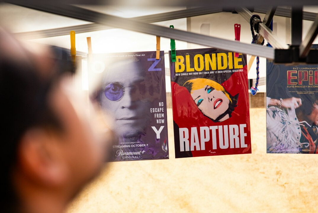 Diverse team of magazine editors reviewing vintage advertising posters together